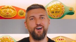 Carl Froch stands in front of his collection of title belts